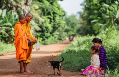 Cambodian Mom and Daughter Offer Alm to Monk on Their Morning Rounds