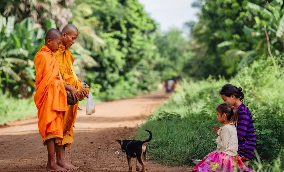 Cambodian Mom and Daughter Offer Alm to Monk on Their Morning Rounds