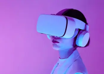 Woman explores virtual reality with VR goggles in modern studio light.