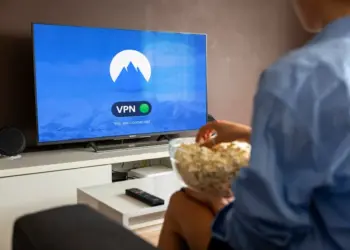 A relaxed scene at home with a person enjoying popcorn while watching a VPN-protected TV.