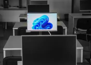 A contemporary office setup featuring computers on desks with modern flat screens.