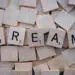 Idade Mental: O Que Isso Revela Sobre Você Em 2026! 11 Close-up of wooden Scrabble tiles spelling the word 'DREAM', symbolizing creativity and imagination.